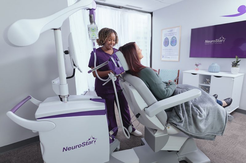 Image of patient sitting in a NeuroStar chair with a physician