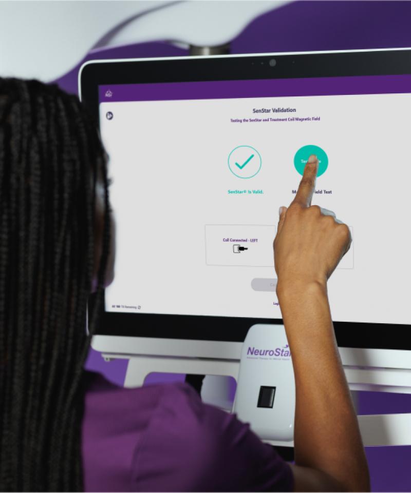 Image of NeuroStar Technician with touch screen.