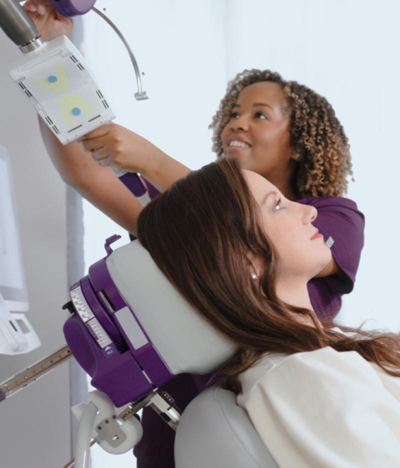 Patient sitting in NeuroStar chair with Care Team Member